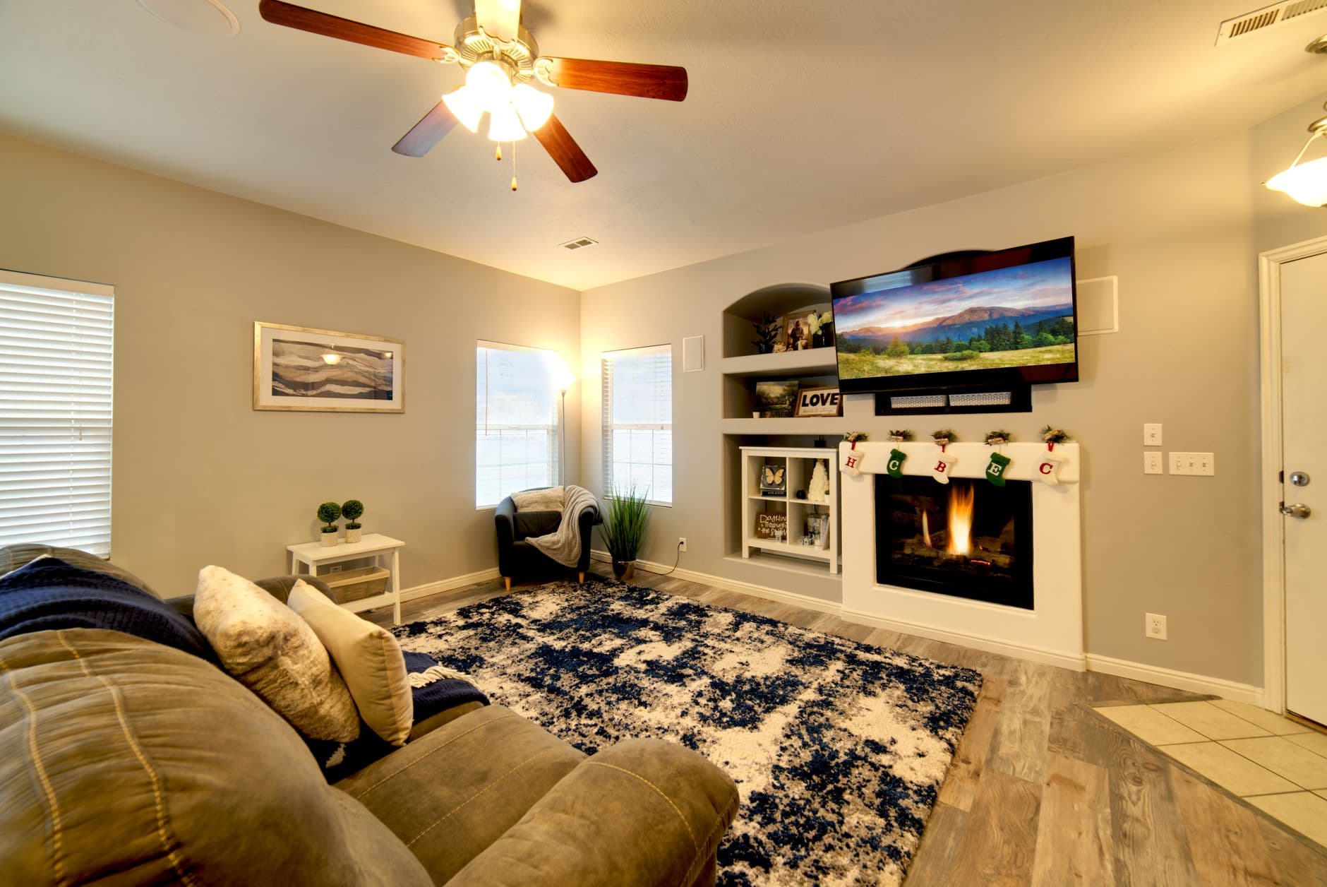 A warm and inviting modern living room with a fireplace and comfortable seating area.